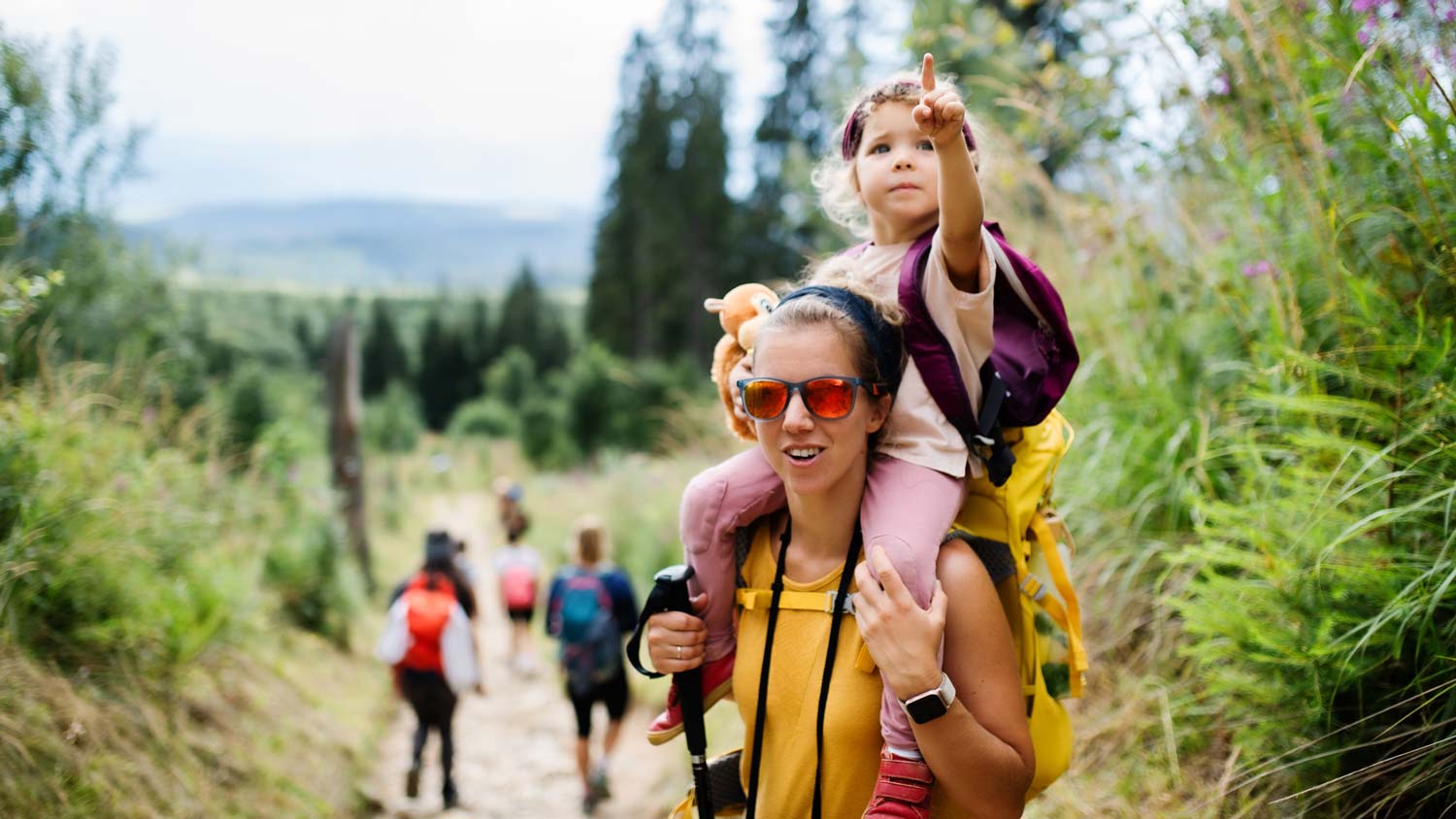 hiking woman with child on back