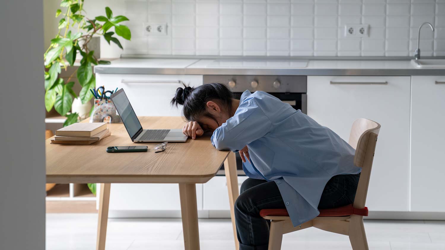 Exhausted freelancer resting head on table
