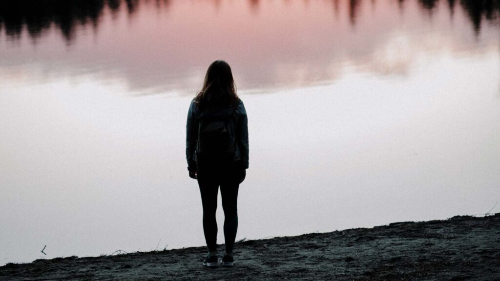 Woman standing at lake shore