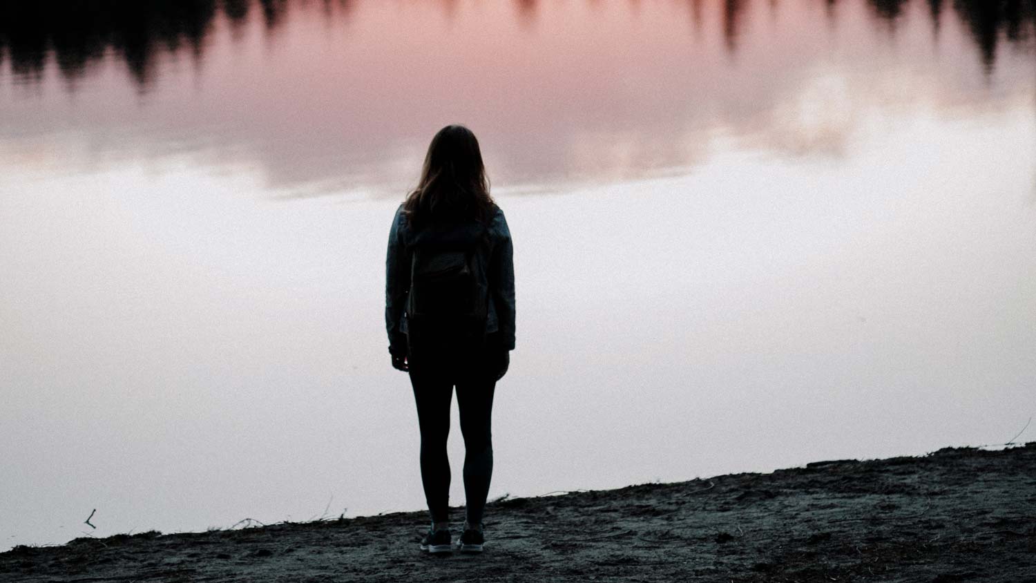 Woman standing at lake shore