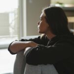woman visible upset looking out of window