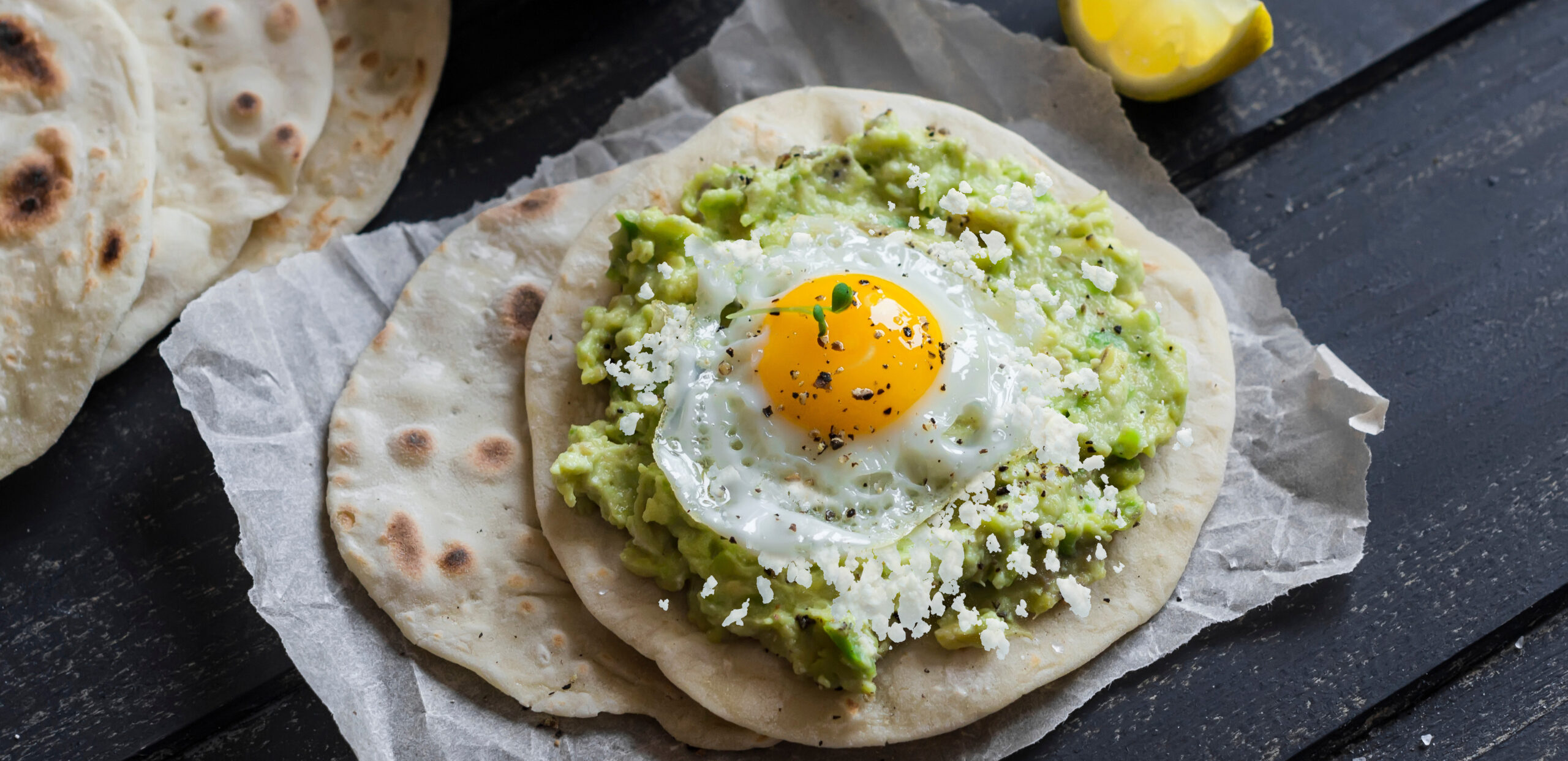 Homemade tortilla with mashed avocado and a fried quail egg. Del