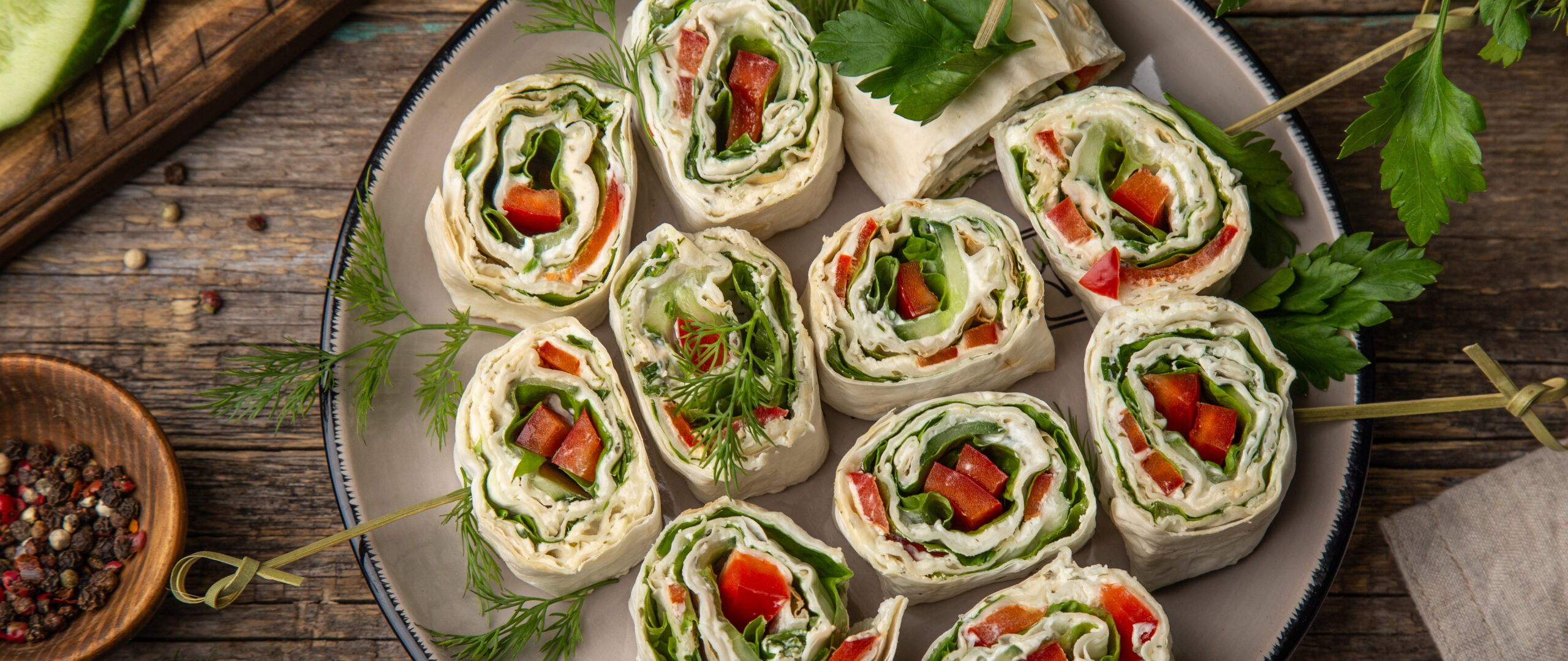 vegetables and cream cheese roll ups, selective focus, wooden background