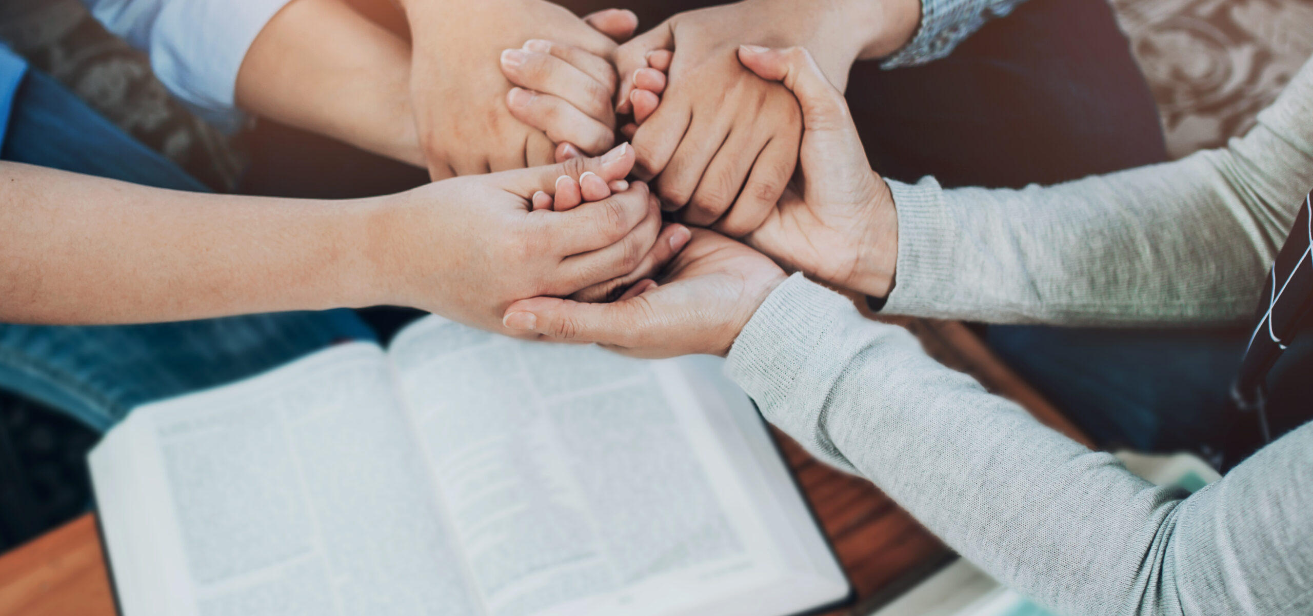 Close up of  people group holding a hand and pray together over